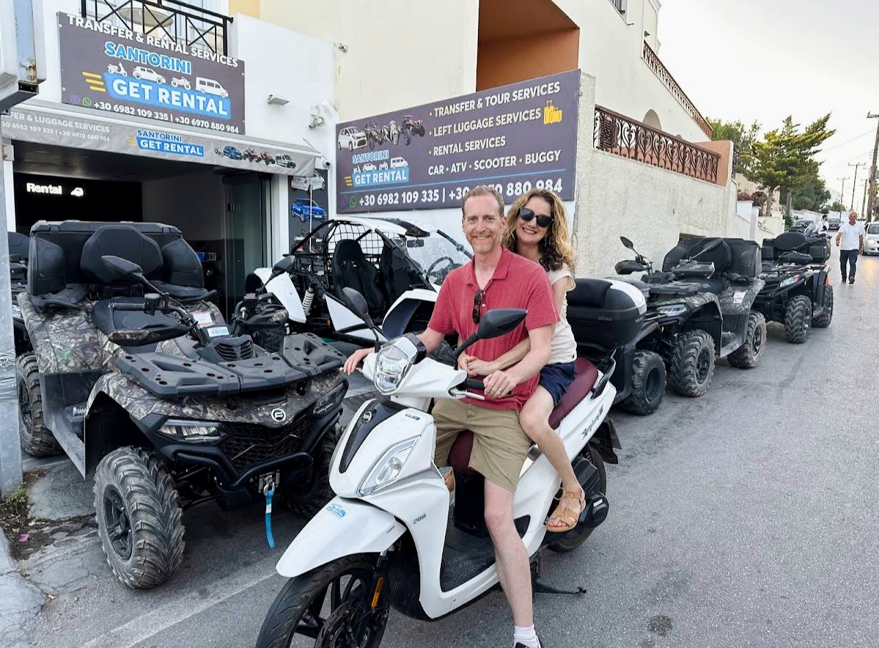 Customers picking up a scooter outside our Santorini rental office